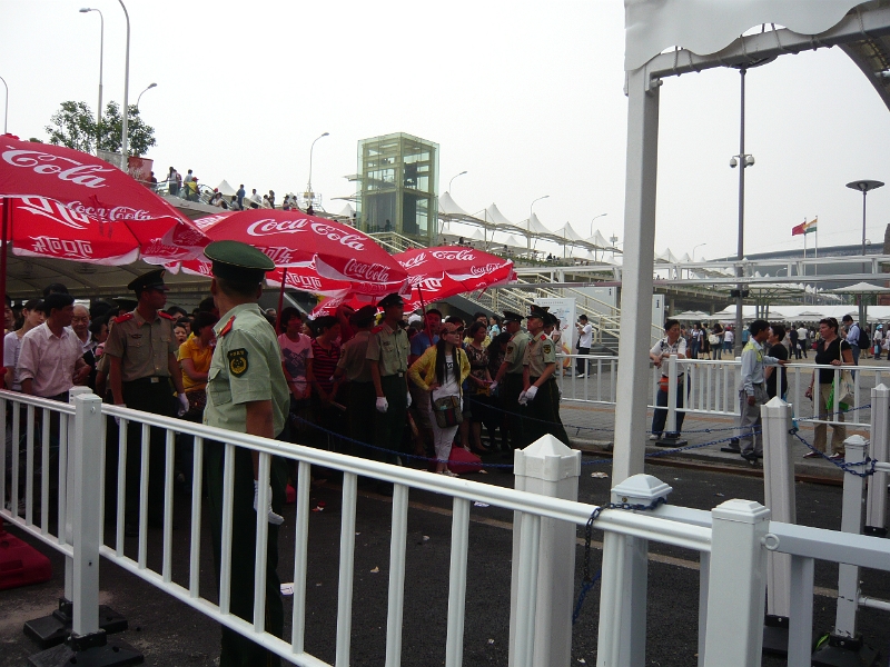 P1030224.JPG - The guards prepare to unchain a section of queueing leading to the Saudi Arabia pavilion. (We had been in this queue the previous morning.)