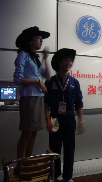 P1030248.JPG - The guide gives directions to the crowd in Chinese.  She also has the same sort of doofy cowboy hat, because it was Texas Week, that we had to wear during our Texas Week back in 2005.
