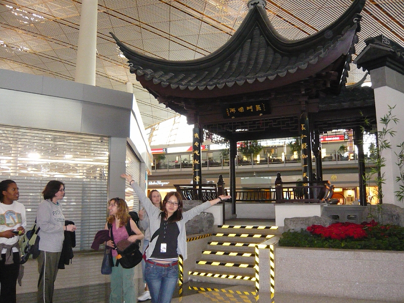 p1020093.jpg - Minami poses in front of what is no doubt a World Heritage Chinese temple, while Nikki, Anna, and Annie talk in the background.