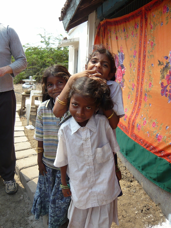 p1020130.jpg - These girls became my personal fan club.  I don't know what I did to earn their admiration but they were my friends for the rest of the trip, usually attached to my arms.  The little girl in the front is Anu, and behind her in the stripes is Nikita.  I really wish I could remember the third girl's name.