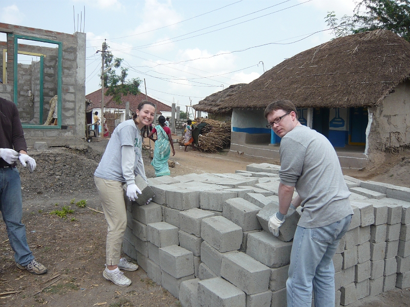 p1020145.jpg - Megan and Joel are moving a pile of bricks toward the house in the previous picture, and I should be helping.  We got that whole pile moved and stacked into a wall in the next few days.